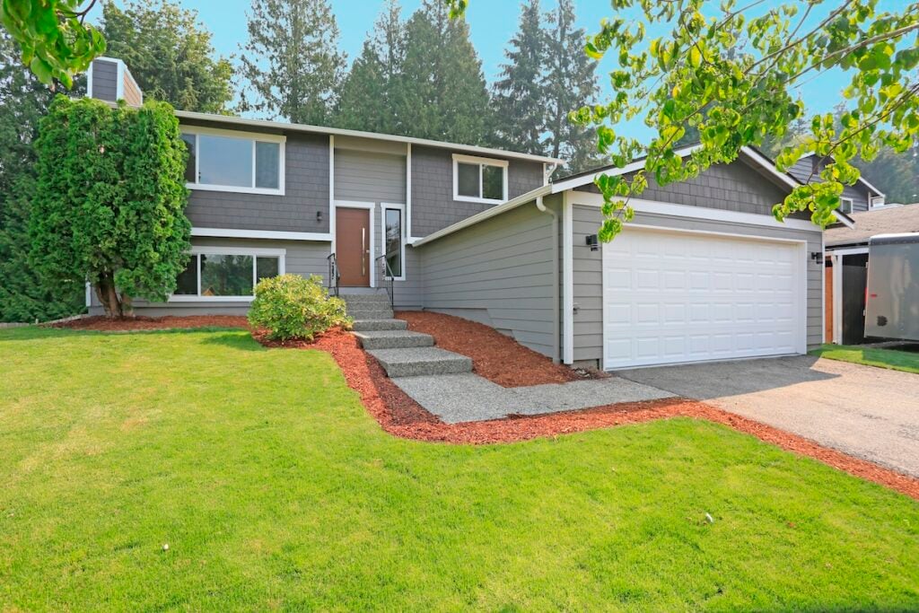 Lovely grey rambler house exterior features grey siding