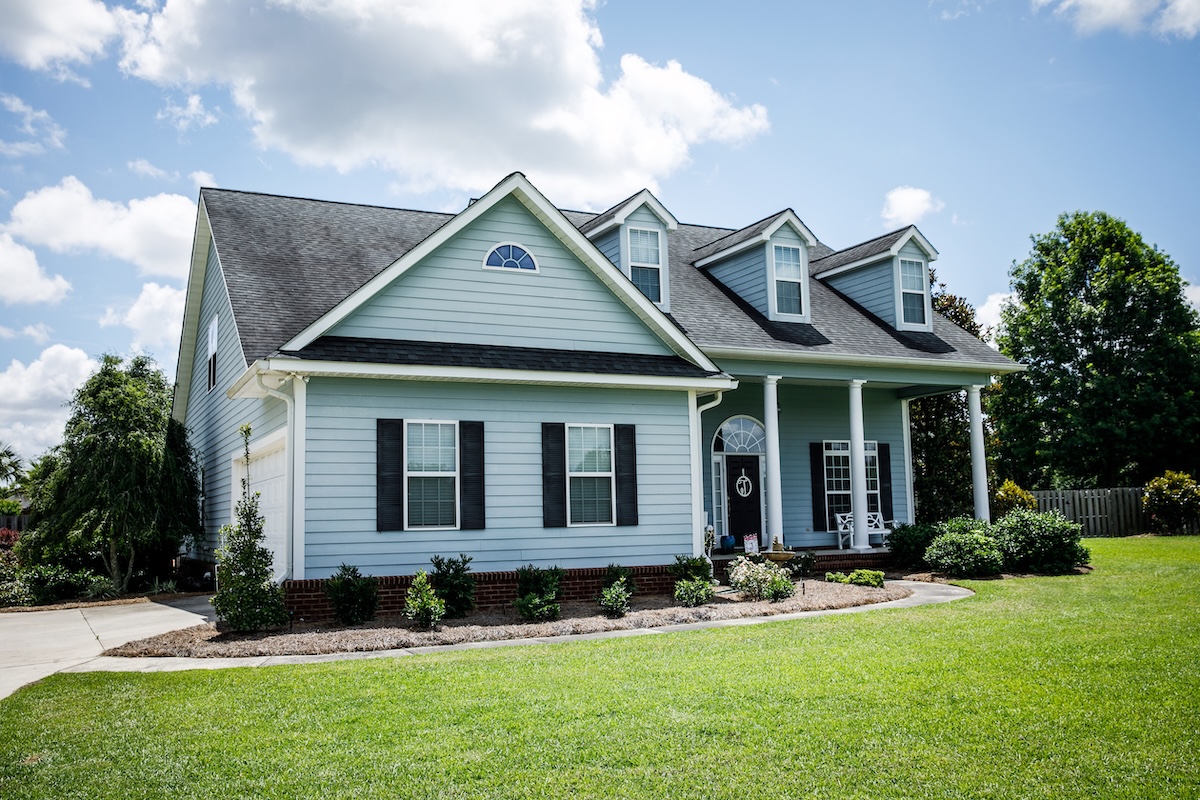 Blue Traditional Siding House Home in Suburbs Front Facing with Curb Appeal