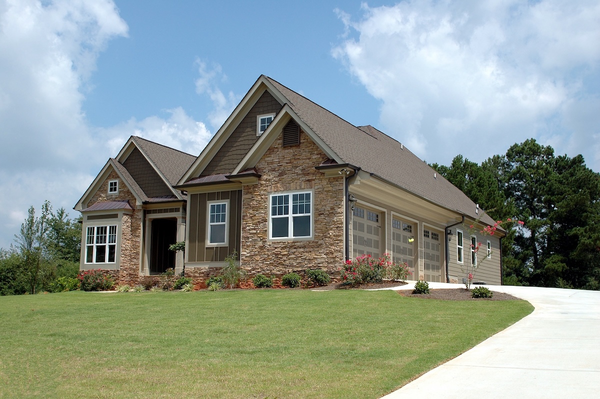 a house with a driveway and grass