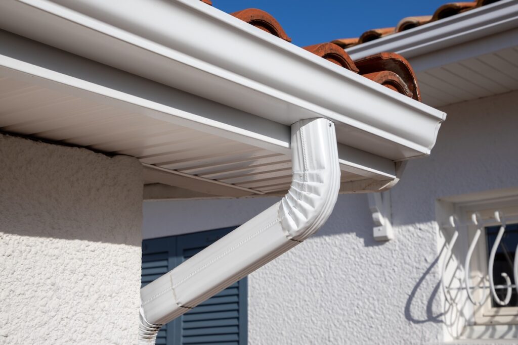 white gutter guard system siding at a luxury single family home neighborhood