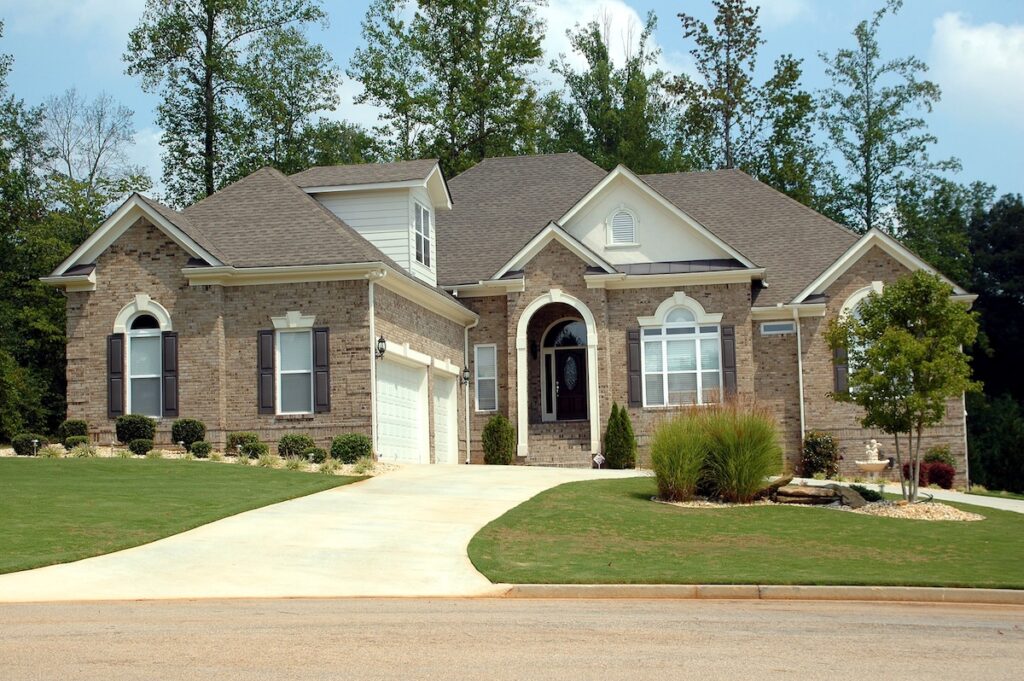 a house with a driveway and trees