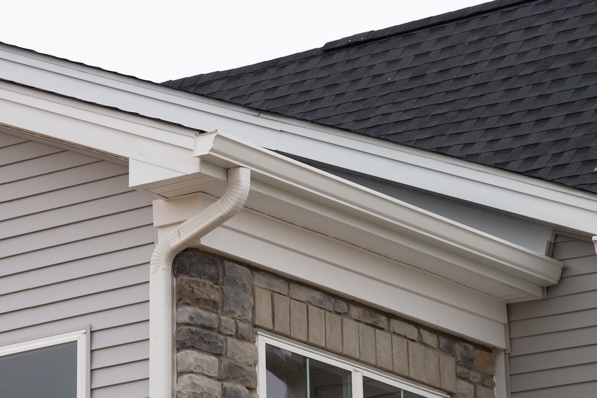 white plastic rain guttering system guttering drainage pipe exterior background of sandwich panel roof wall holder