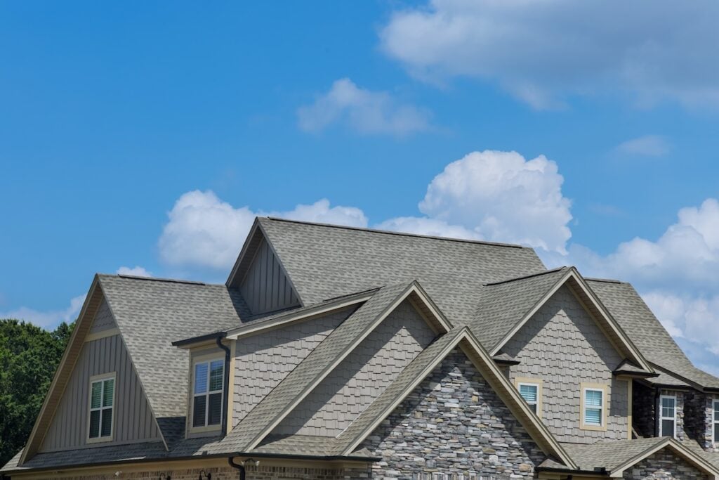 Roof construction of a building roof that is covered with new asphalt shingles how to measure a roof for shingles
