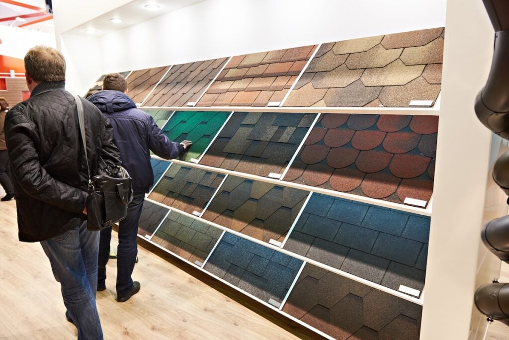 Buyers in the construction shop choose the soft roof tiles