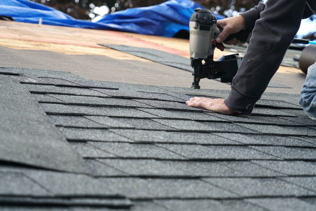 a person using a nail gun on a roof