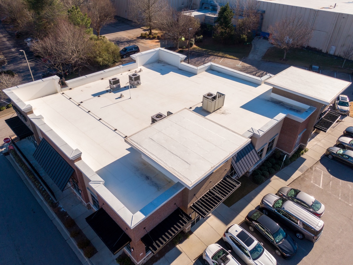 Sunny Day Time Drone Images of a TPO Roof on a Commercial Building.