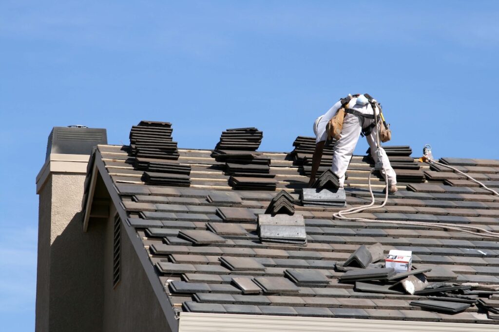 roofer on a roof with tiles