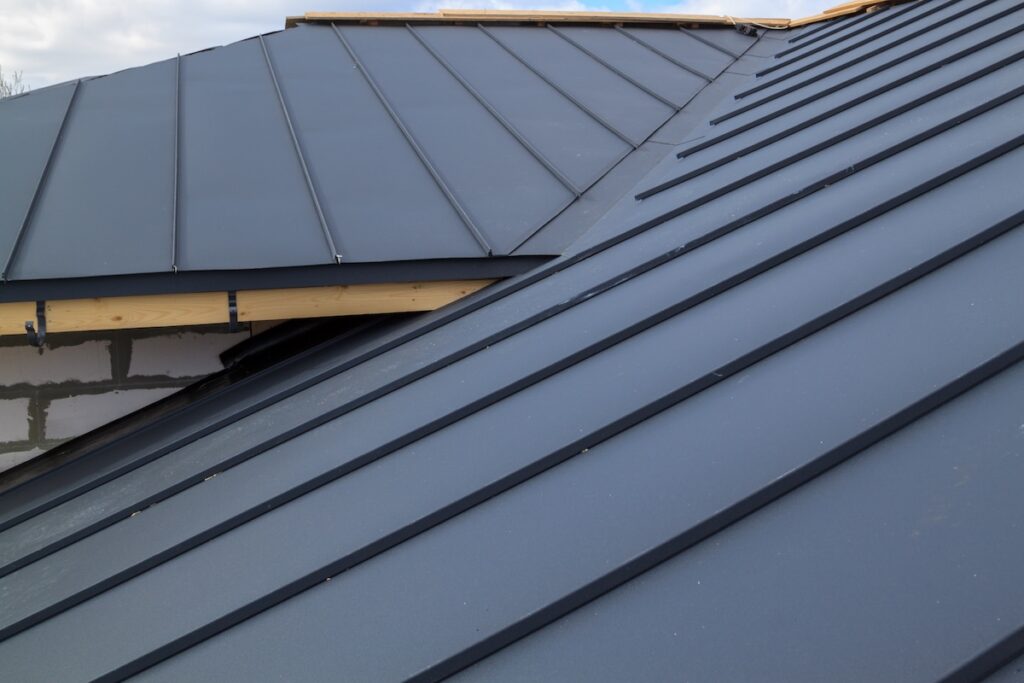 Interestingly solved roof surface. Roof made of metal roof tiles. metal roofing types