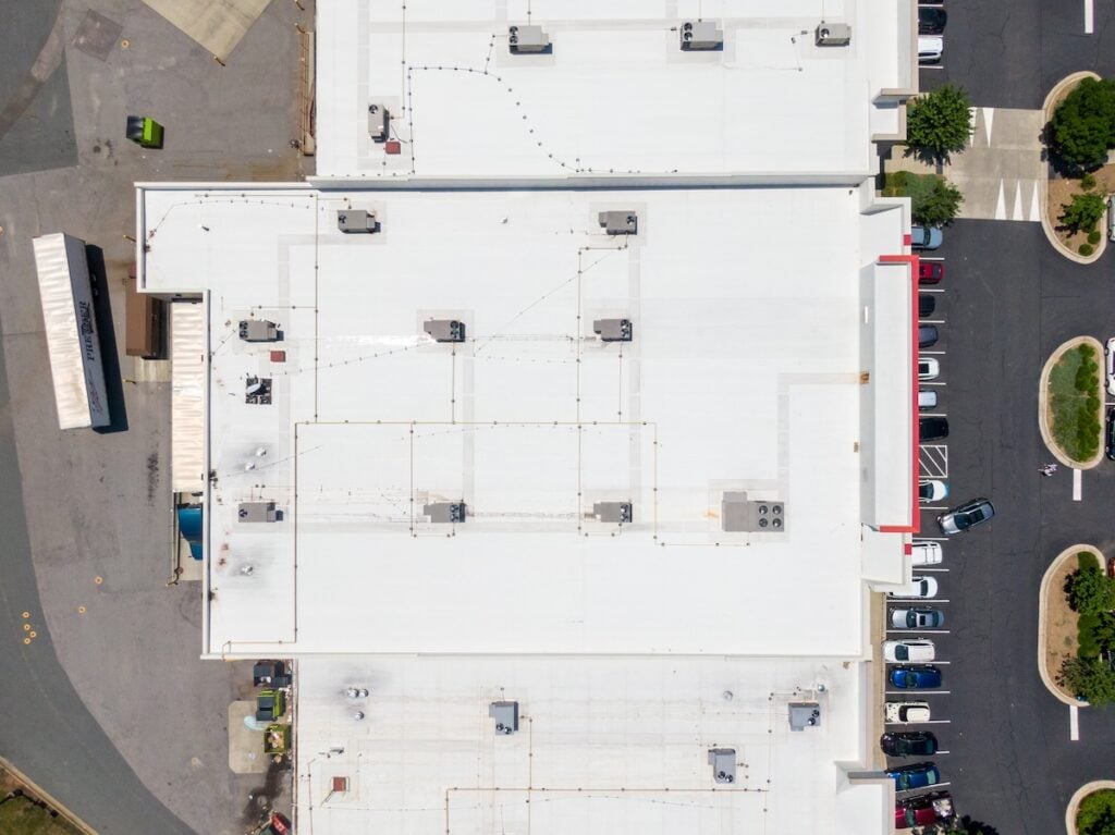 tpo roofing cost Drone Images of Commercial Roofs Featuring TPO and Asphalt Shingles: Midday, Sunny, No People