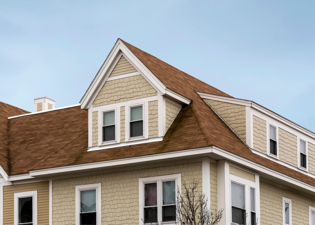 house and roof color combinations Dormer windows on the sloped shingle roof of a newly built house in Brighton, MA, USA