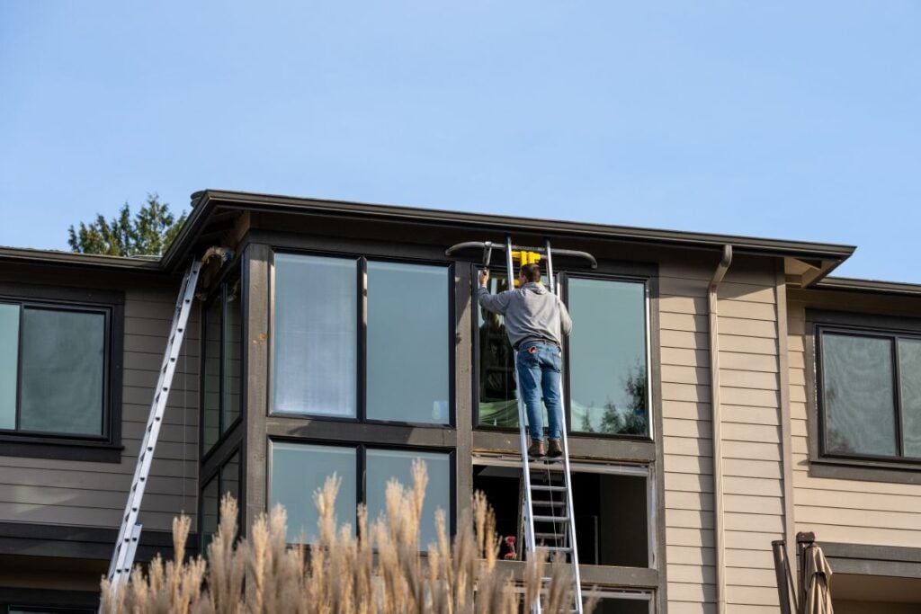 raleigh nc window installers worker installing long window