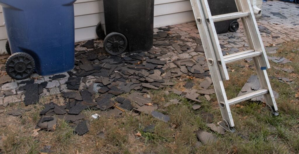 roof damage shingles falling apart on the ground