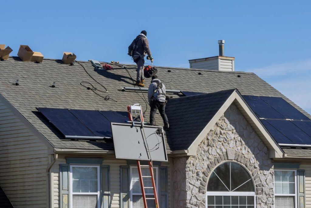 solar maintenance services charcoal shingles roof workers installing panels