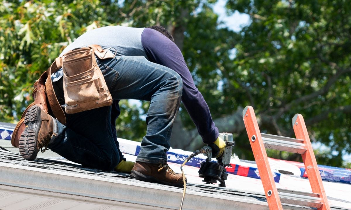 wake county roofing companies worker using nail gun to repair shingles roof