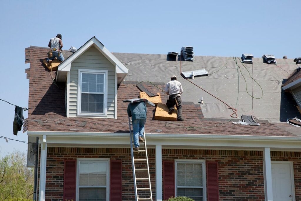 wake county roofing companies workers repairing roof after storm