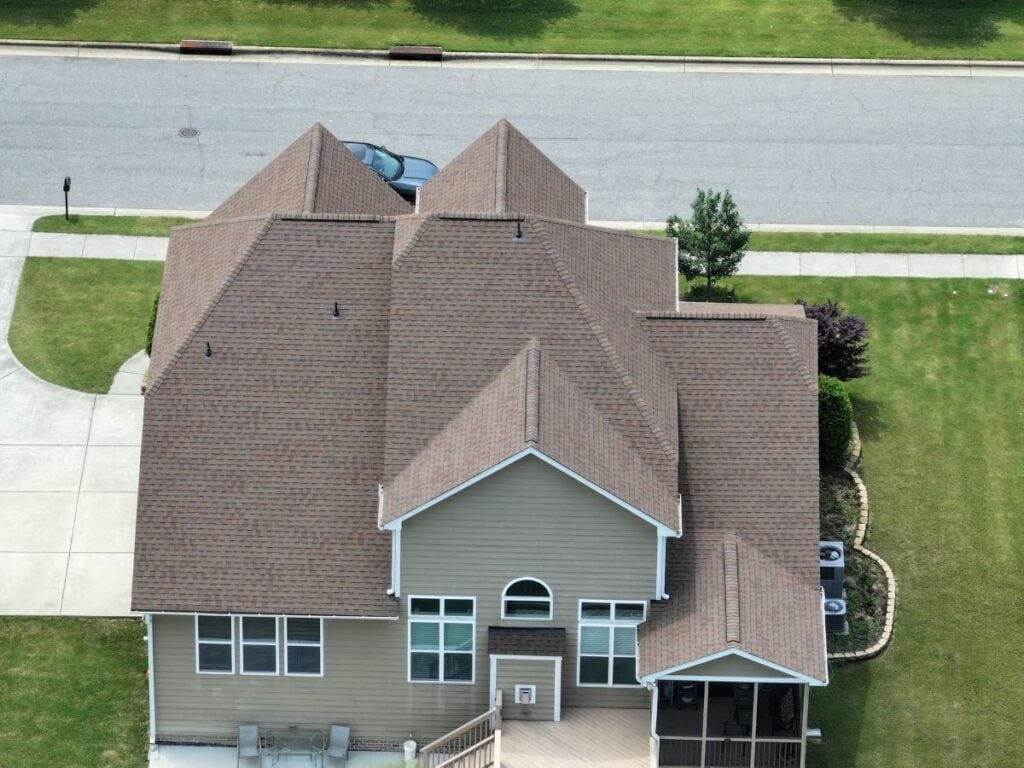 aerial view of tan shingles on a pitched roof