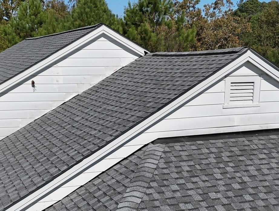A newly installed grey shingle roof