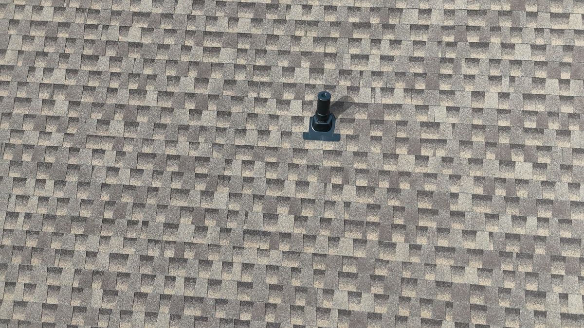 a shingle roof with a vent