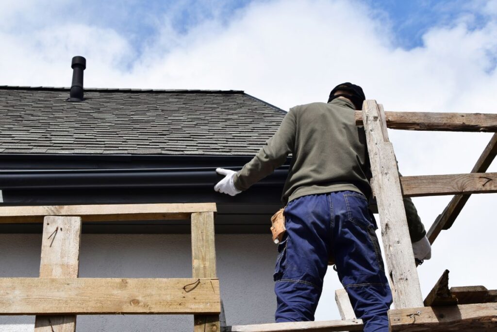 roof and gutter cleaning gutter installation worker installing new water system