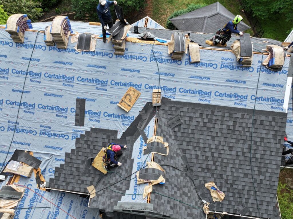 low slope roof Berkley Jensen project workers replacing shingles