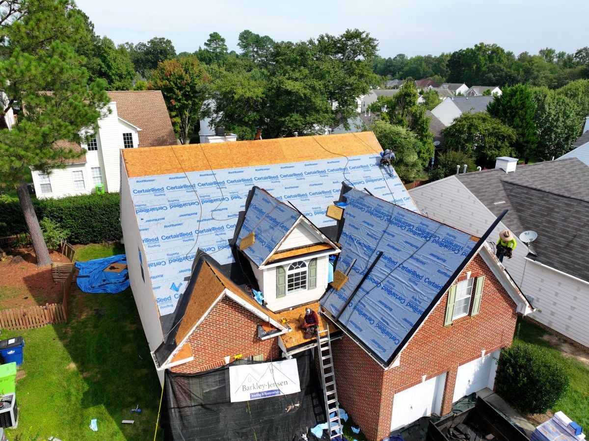 what does a roof replacement cost in raleigh nc Berkley Jensen workers replacing old shingles