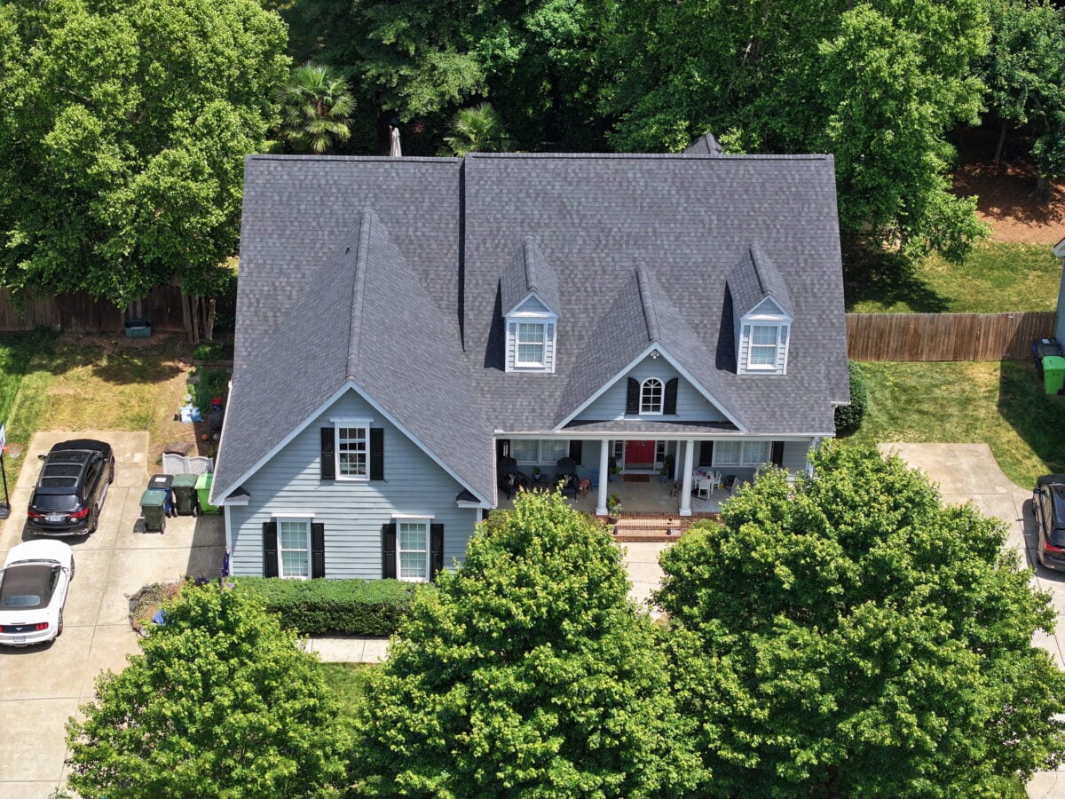 what type of shingles are recommended in chapel hill nc dark shingles roof big house surrounded by trees