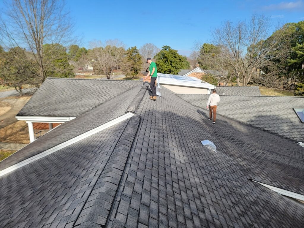 best roofing companies in wake forest nc two men on top of shingles roof