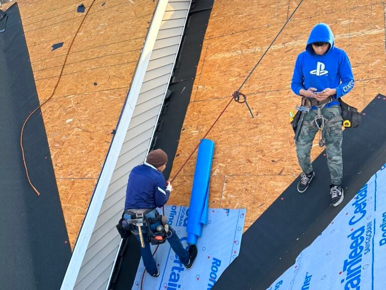 what warranties are offered for roofing in holly springs nc workers replacing shingles on top of roof 