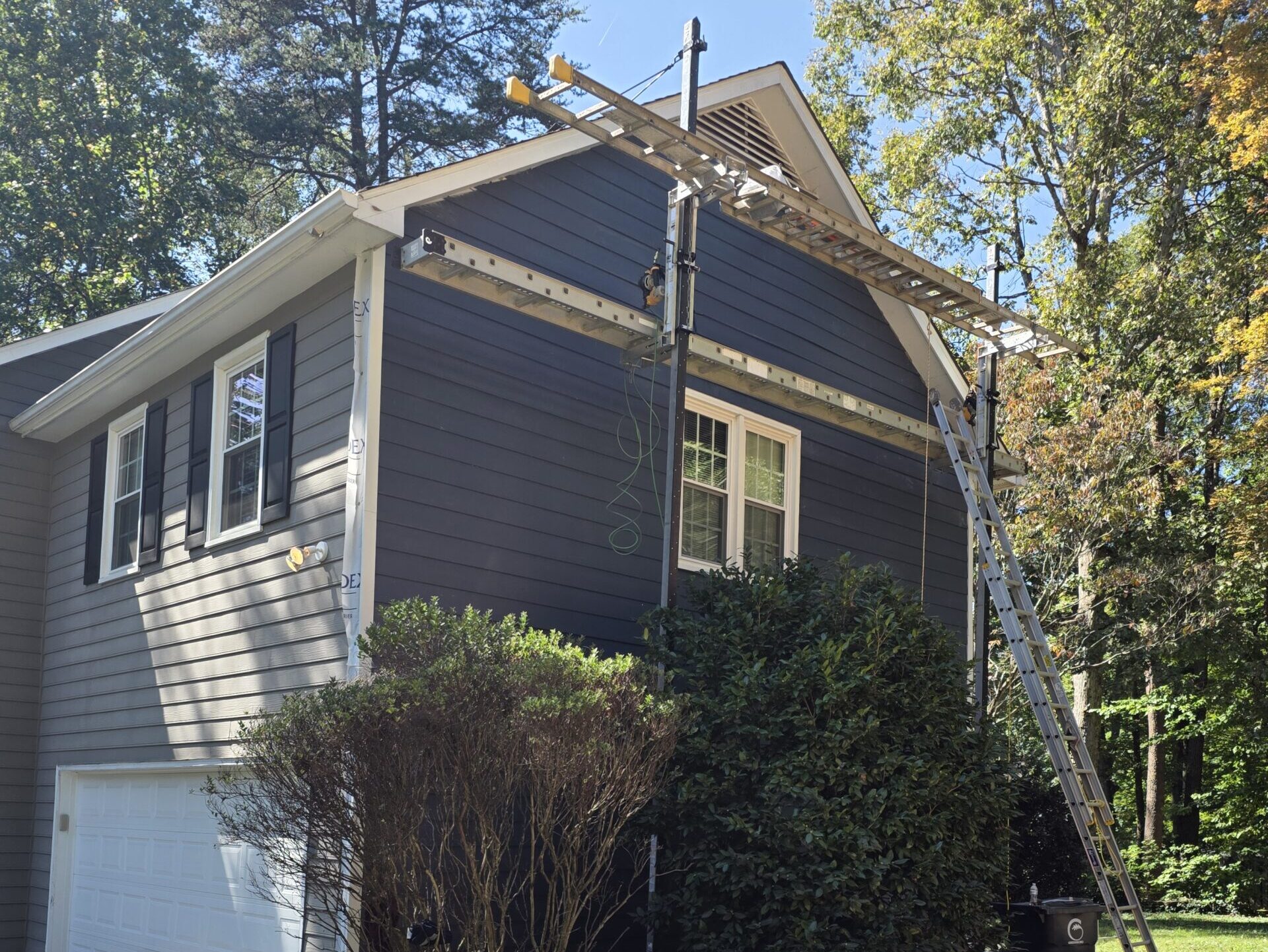 siding pinehurst nc blue house workers using structure to replace front